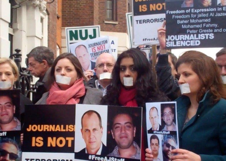 Egypt Pardons Al Jazeera Journalists – freedom Peter Greste protestors taped mouths