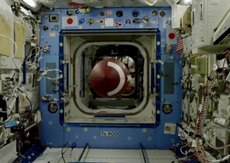 Super Bowl Astronaut Throws Football and breaks record right through the middle