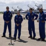 astronauts talking to media