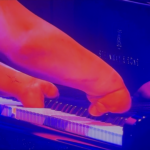 hits notes using palm of hand